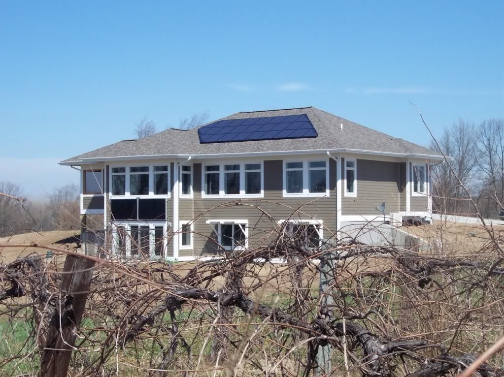 South elevation show solar hot water panels and photovoltaic roof panels.